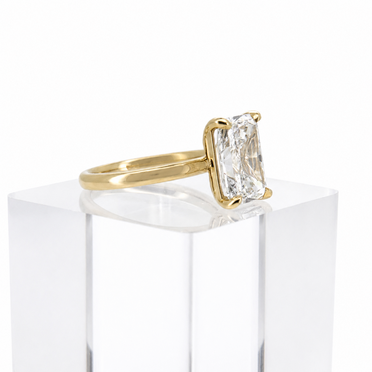 3.01ct E VS1 radiant lab grown diamond ring in 14K yellow gold, three-quarter view